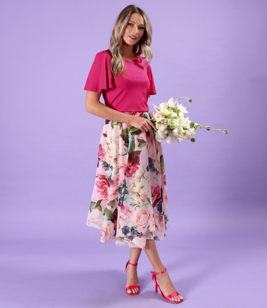 Elegant outfit with blouse with wide sleeves and midi skirt made of veil printed with flowers