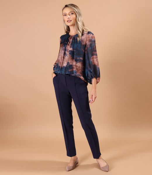 Elegant outfit with ankle pants and printed veil blouse